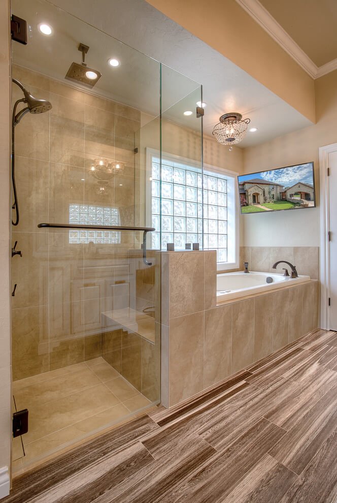 Modern walk-in shower renovation in Miami Beach - Custom tile work and frameless glass enclosure