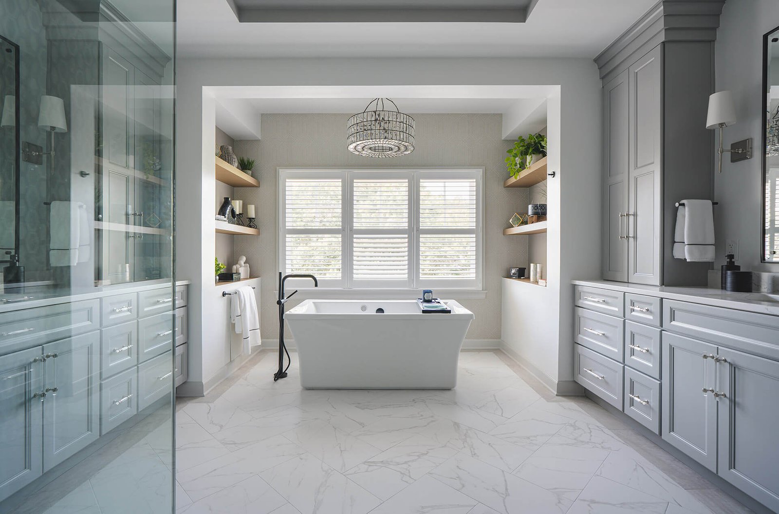 Luxury bathroom remodeling showcase in Hialeah with a freestanding tub, custom cabinetry, and bright modern finishes